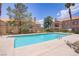Community pool area with lounge chairs and well-maintained landscaping at 3455 Erva St # 112, Las Vegas, NV 89117