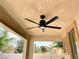 Covered back porch with ceiling fan and view of landscaped backyard at 3809 Van Ness Ave, North Las Vegas, NV 89081
