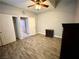 This bedroom features stylish wood floors, a ceiling fan, and access to another room at 3809 Van Ness Ave, North Las Vegas, NV 89081