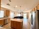 Open concept kitchen with stainless steel appliances and center island flows into the living area at 3809 Van Ness Ave, North Las Vegas, NV 89081