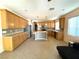 Open kitchen with stainless appliances, a center island, and seamless flow to living area at 3809 Van Ness Ave, North Las Vegas, NV 89081