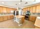 Well-lit kitchen with stainless steel appliances, gas range, center island, and ample cabinet space at 3809 Van Ness Ave, North Las Vegas, NV 89081