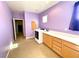 Bright laundry room with washer, dryer, storage cabinets, counter space, and tiled floor at 3809 Van Ness Ave, North Las Vegas, NV 89081