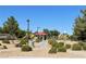 A scenic view of the community park with playground and picnic shelter nestled in a green space at 3809 Van Ness Ave, North Las Vegas, NV 89081