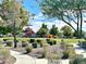 A serene view of the community park with walking path, playground, and manicured greenery under a clear sky at 3809 Van Ness Ave, North Las Vegas, NV 89081