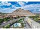 Beautiful aerial view of the community pool, desert landscape, and surrounding mountains at 3880 Enchanted Sky St, Las Vegas, NV 89129