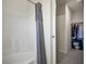 Clean bathroom featuring a tub and shower combination, complemented by a walk-in closet at 3880 Enchanted Sky St, Las Vegas, NV 89129