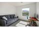 Comfortable bedroom with a blue couch, work station, and scenic views of the mountains at 3880 Enchanted Sky St, Las Vegas, NV 89129