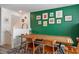 Inviting dining room featuring green accent wall and table set for six at 3880 Enchanted Sky St, Las Vegas, NV 89129