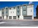 Modern townhouse exterior with gray accents, two-car garage, and well-maintained landscaping at 3880 Enchanted Sky St, Las Vegas, NV 89129
