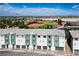 Contemporary townhouse exterior with attached garages, modern color palette and neighborhood ballfields at 3880 Enchanted Sky St, Las Vegas, NV 89129