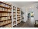Bright hallway with built-in bookshelves, wood floors, and a view to the outside patio at 3880 Enchanted Sky St, Las Vegas, NV 89129