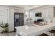 This kitchen features white cabinets, stainless steel appliances and an island with seating at 3880 Enchanted Sky St, Las Vegas, NV 89129