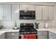 This kitchen features gray cabinets, stainless steel appliances, and light countertops at 3880 Enchanted Sky St, Las Vegas, NV 89129