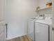 Functional laundry room with a side-by-side washer and dryer and a storage shelf at 3880 Enchanted Sky St, Las Vegas, NV 89129
