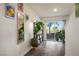 Bright living room featuring wood-look floors, a large sliding glass door, and decorative plants at 3880 Enchanted Sky St, Las Vegas, NV 89129