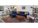 Stylish living room with a cozy blue sectional, wood coffee table, and modern decor at 3880 Enchanted Sky St, Las Vegas, NV 89129