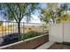 Relaxing outdoor patio featuring a retaining wall and scenic views beyond the fence at 3880 Enchanted Sky St, Las Vegas, NV 89129