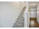 Carpeted staircase leading to the upper level of the home with natural light, and white walls at 3880 Enchanted Sky St, Las Vegas, NV 89129