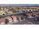 High angle aerial of a neighborhood street displaying home with palm trees and scenic mountain backdrop at 3913 Lilac Haze St, Las Vegas, NV 89147