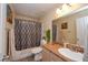 Well-lit bathroom with shower-tub combination, granite counters, and decorative accents at 3913 Lilac Haze St, Las Vegas, NV 89147