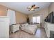 Spacious bedroom offering a ceiling fan, neutral colors, tile floors, and abundant natural light at 3913 Lilac Haze St, Las Vegas, NV 89147
