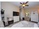 Comfortable bedroom suite showcases tile floors, an ensuite bathroom, and elegant decor with ceiling fan at 3913 Lilac Haze St, Las Vegas, NV 89147
