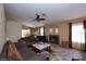 Spacious living room with a fireplace, ceiling fan, and a cozy seating area, creating a welcoming atmosphere at 3913 Lilac Haze St, Las Vegas, NV 89147