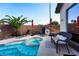 Backyard oasis with a sparkling pool, spa, lounging chairs, and a built-in outdoor kitchen at 3913 Lilac Haze St, Las Vegas, NV 89147