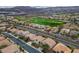 Picturesque neighborhood adjacent to a lush green golf course, set against a backdrop of rolling mountains at 404 Via Sonador, Henderson, NV 89012