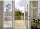 View from balcony through open doors with white plantation shutters and exterior greenery at 404 Via Sonador, Henderson, NV 89012