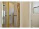 Well-lit bathroom featuring a glass-enclosed shower and neutral-toned tile work at 404 Via Sonador, Henderson, NV 89012