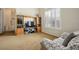 Partial view of the bedroom showing a TV, shutters, and a sitting area with patterned cover at 404 Via Sonador, Henderson, NV 89012