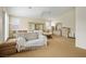 Large bedroom featuring a ceiling fan, bright windows, a bed, and an upholstered sofa at 404 Via Sonador, Henderson, NV 89012