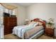 Comfortable bedroom with wooden dresser and a cushioned bed, showcasing a cozy interior at 404 Via Sonador, Henderson, NV 89012