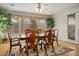 Bright dining area with hardwood floors features large windows with decorative valances and a stylish chandelier at 404 Via Sonador, Henderson, NV 89012