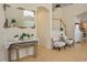 Inviting entryway with decorative mirror, console table, and staircase with white railings at 404 Via Sonador, Henderson, NV 89012