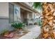 Inviting front porch with stone walkway, comfortable seating, and vibrant potted plants at 404 Via Sonador, Henderson, NV 89012