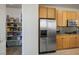 Well-organized kitchen with stainless steel refrigerator and a fully stocked pantry at 404 Via Sonador, Henderson, NV 89012