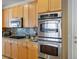 Sleek kitchen featuring double ovens, cooktop, and granite countertops at 404 Via Sonador, Henderson, NV 89012