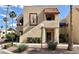 Beige condo building featuring a brown framed entry and manicured shrubs at 4151 Sanderling Cir # 351, Las Vegas, NV 89103