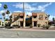Beige condo buildings showcasing a unique brown framed entry with palm tree landscaping at 4151 Sanderling Cir # 351, Las Vegas, NV 89103