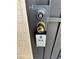 A close up of a front door with a lockbox attached at 4151 Sanderling Cir # 351, Las Vegas, NV 89103