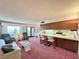 Open-concept living room and kitchen combo with pink carpet at 4151 Sanderling Cir # 351, Las Vegas, NV 89103