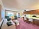 Open-concept living room and kitchen featuring pink carpet at 4151 Sanderling Cir # 351, Las Vegas, NV 89103