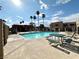 Sparkling community pool with plenty of seating and lounge chairs under the bright, sunny sky at 4151 Sanderling Cir # 351, Las Vegas, NV 89103