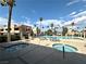 Community pool and two hot tubs surrounded by palm trees, seating, and well-maintained grounds at 4151 Sanderling Cir # 351, Las Vegas, NV 89103