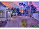 Beautiful backyard with desert landscaping, palms, and an outdoor structure at 4418 Desert Bloom Ct, Las Vegas, NV 89129