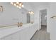 Bathroom featuring a large mirror, vanity, double sinks, and gold fixtures at 4418 Desert Bloom Ct, Las Vegas, NV 89129