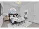 Beautiful staged bedroom with decorative pillows, bench and carpet at 4418 Desert Bloom Ct, Las Vegas, NV 89129